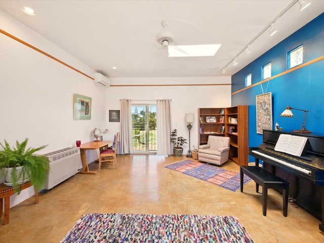 54 Encantado Loop, Santa Fe, NM 87508 - living room featuring track lighting, finished concrete floors, a skylight, a wall mounted air conditioner, and radiator