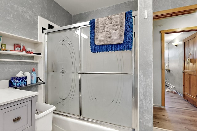 26 Apache Creek Rd, Santa Fe, NM 87505 - bathroom with wood finished floors, combined bath / shower with glass door, and vanity