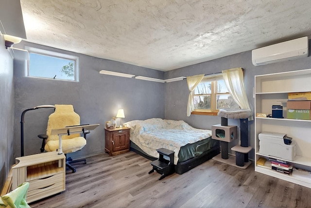 26 Apache Creek Rd, Santa Fe, NM 87505 - bedroom with an AC wall unit and wood finished floors