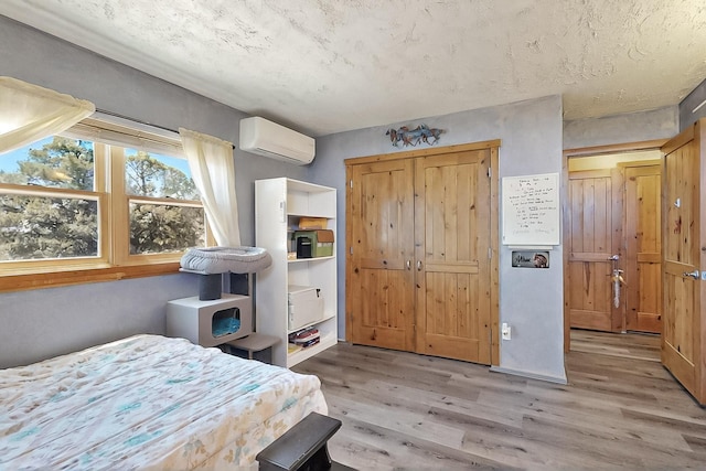 26 Apache Creek Rd, Santa Fe, NM 87505 - bedroom featuring an AC wall unit, wood finished floors, and a closet