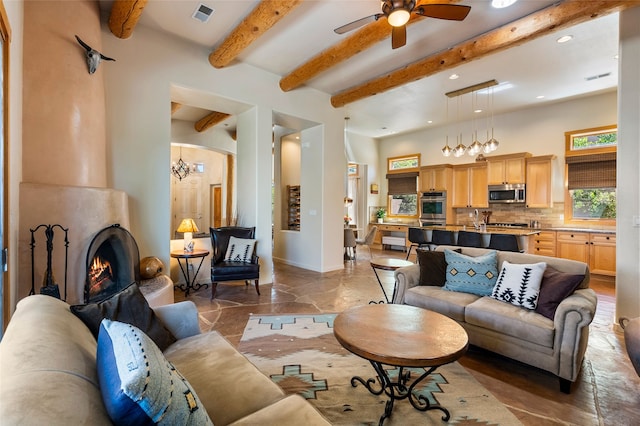 88 Canada Del Rancho, Santa Fe, NM 87508 - living room with beam ceiling, ceiling fan, recessed lighting, baseboards, and a large fireplace