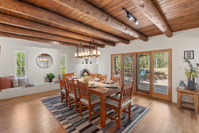 2005 Zozobra Ln, Santa Fe, NM 87505 - dining space with wooden ceiling, light wood finished floors, beam ceiling, healthy amount of natural light, and a chandelier