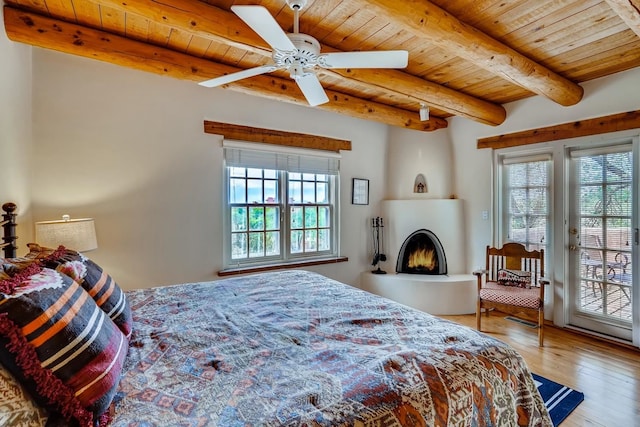 334 Otero Unit 14-3, Santa Fe, NM 87501 - bedroom with wood ceiling, multiple windows, access to exterior, wood-type flooring, and beamed ceiling