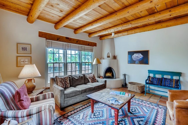 334 Otero Unit 14-3, Santa Fe, NM 87501 - living area featuring wooden ceiling, tile patterned flooring, beam ceiling, and a large fireplace