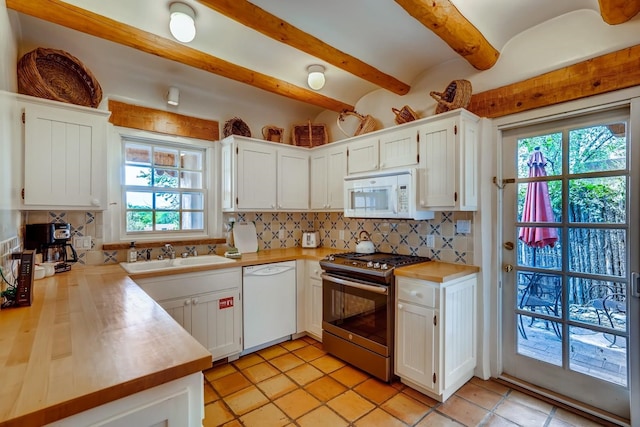 334 Otero Unit 14-3, Santa Fe, NM 87501 - kitchen featuring white appliances, a sink, beam ceiling, decorative backsplash, and white cabinets