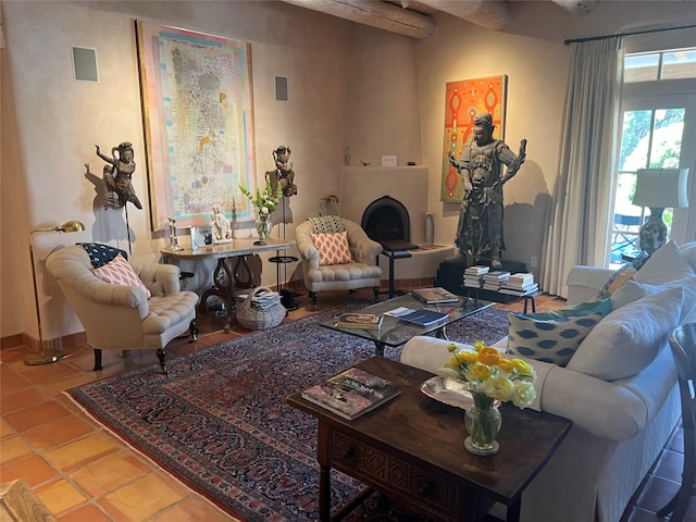 living room with tile patterned flooring and a large fireplace