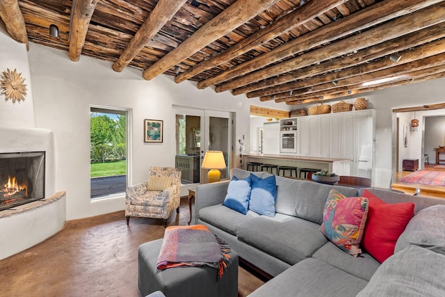 127 County Road 84, Santa Fe, NM 87506 - living area featuring wood ceiling, beam ceiling, and a large fireplace
