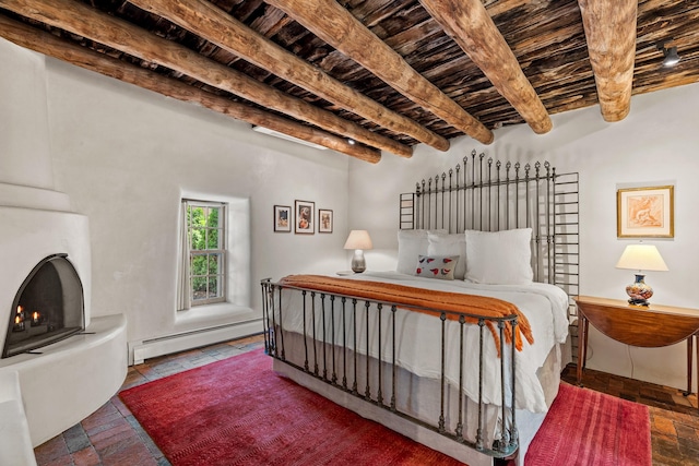 127 County Road 84, Santa Fe, NM 87506 - bedroom featuring baseboard heating, wood ceiling, beamed ceiling, brick floors, and a warm lit fireplace
