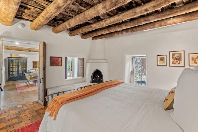 127 County Road 84, Santa Fe, NM 87506 - bedroom featuring wood ceiling, beamed ceiling, and brick floors