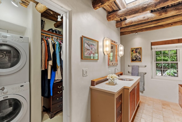 127 County Road 84, Santa Fe, NM 87506 - laundry area with stacked washer / drying machine, a sink, and wood ceiling