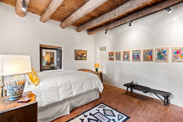 127 County Road 84, Santa Fe, NM 87506 - bedroom with rail lighting, brick flooring, wooden ceiling, beamed ceiling, and a high ceiling