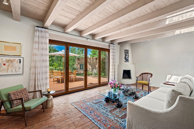 127 County Road 84, Santa Fe, NM 87506 - living room featuring wood ceiling, brick flooring, plenty of natural light, beam ceiling, and a fireplace