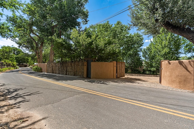 127 County Road 84, Santa Fe, NM 87506 - view of asphalt street featuring a gate