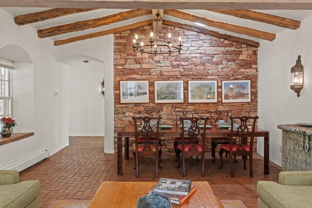 767 Acequia Madre Unit 1, Santa Fe, NM 87505 - dining area with arched walkways, a baseboard heating unit, a chandelier, and brick flooring