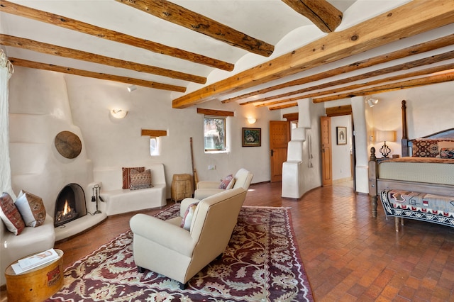 17 Tano W, Santa Fe, NM 87506 - living room with brick flooring, beam ceiling, and a large fireplace