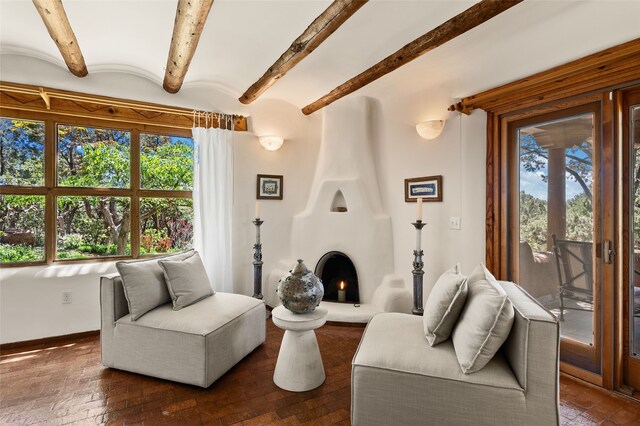 17 Tano W, Santa Fe, NM 87506 - living area featuring beamed ceiling, a large fireplace, and baseboards