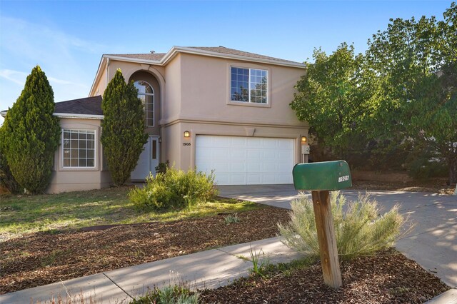 1905 Mendius, Los Alamos, NM 87544 - view of front of property featuring driveway, a garage, and stucco siding