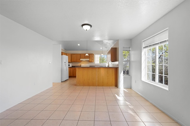 1905 Mendius, Los Alamos, NM 87544 - kitchen featuring white fridge with ice dispenser, healthy amount of natural light, under cabinet range hood, a peninsula, and recessed lighting