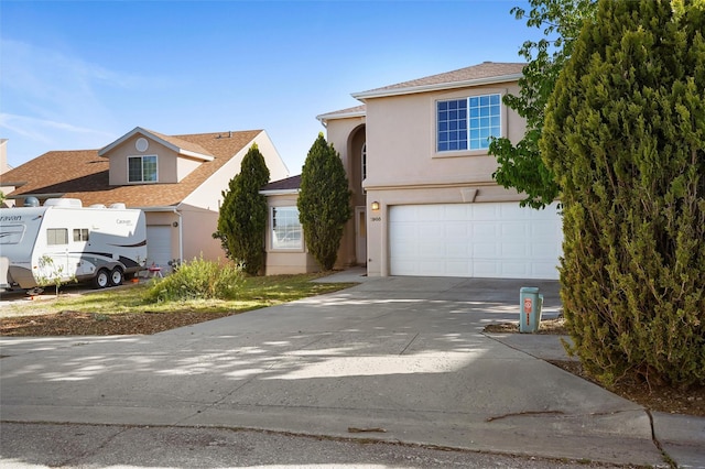 1905 Mendius, Los Alamos, NM 87544 - view of front facade with an attached garage, concrete driveway, and stucco siding