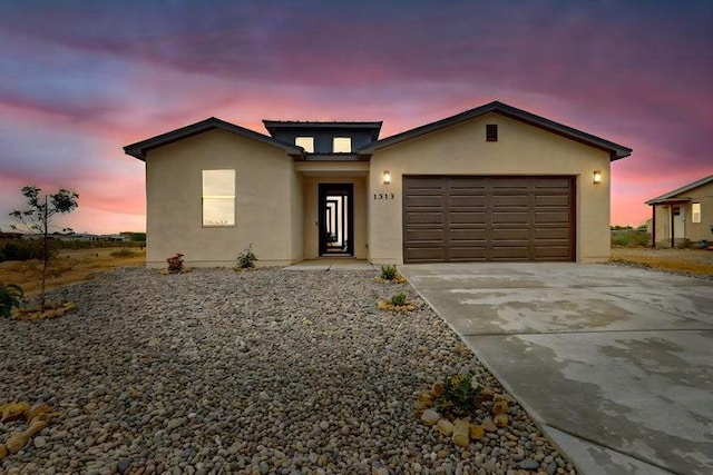1313 Tulip Rd SE, Rio Rancho, NM 87124 - view of front of home featuring driveway, a garage, and stucco siding