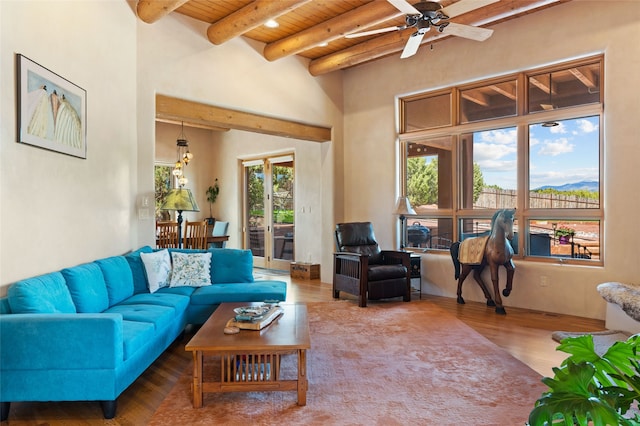 2 Tierra Grande, Santa Fe, NM 87506 - living area featuring wood ceiling with exposed beams, wood finished floors, a ceiling fan, and a high ceiling