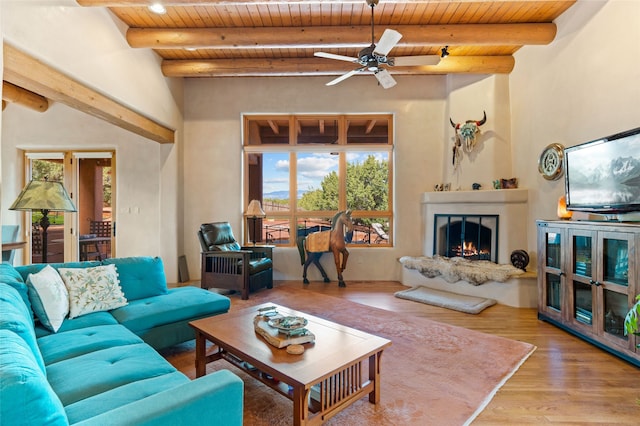 2 Tierra Grande, Santa Fe, NM 87506 - living area featuring wood ceiling with exposed beams, ceiling fan, a fireplace, and wood finished floors