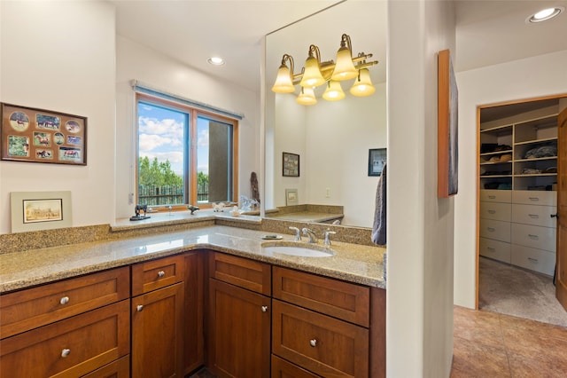 2 Tierra Grande, Santa Fe, NM 87506 - bathroom with vanity, a walk in closet, and recessed lighting
