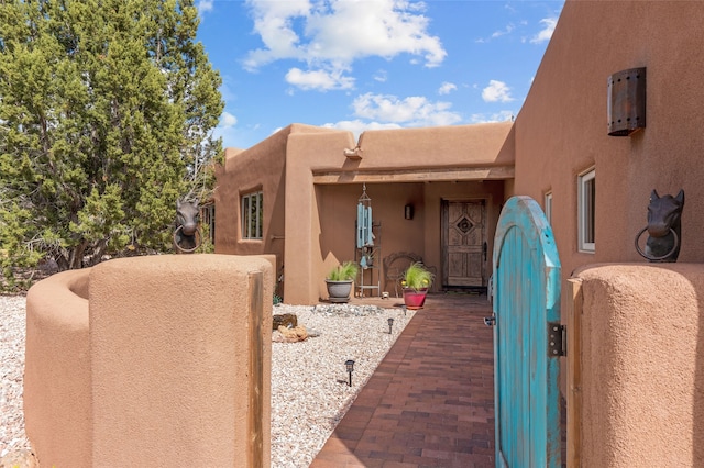 2 Tierra Grande, Santa Fe, NM 87506 - doorway to property featuring stucco siding