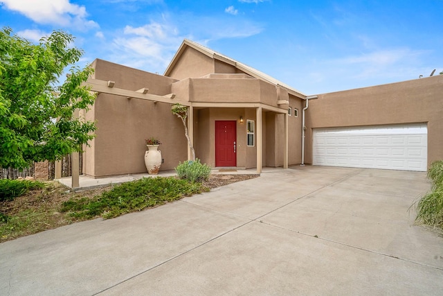 4548 Contenta Rdg, Santa Fe, NM 87507 - adobe home featuring concrete driveway, stucco siding, and a garage
