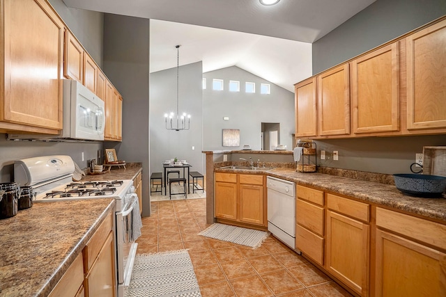 4548 Contenta Rdg, Santa Fe, NM 87507 - kitchen featuring white appliances, vaulted ceiling, light tile patterned floors, a sink, and a chandelier