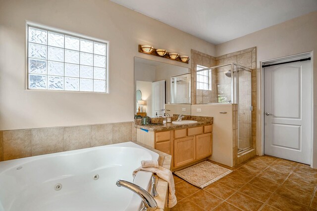 4548 Contenta Rdg, Santa Fe, NM 87507 - bathroom with a stall shower, a jetted tub, vanity, and tile patterned floors