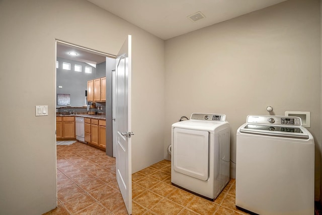 4548 Contenta Rdg, Santa Fe, NM 87507 - washroom with separate washer and dryer and light tile patterned floors