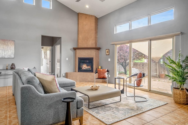 4548 Contenta Rdg, Santa Fe, NM 87507 - tiled living room with a high ceiling, a glass covered fireplace, and a ceiling fan