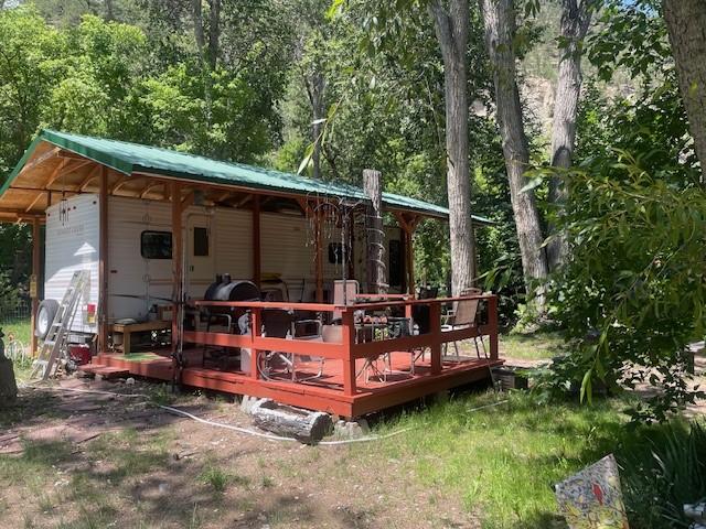 6 Rainbow Trout Ln, Pecos, NM 87552 - rear view of property with metal roof and a wooden deck