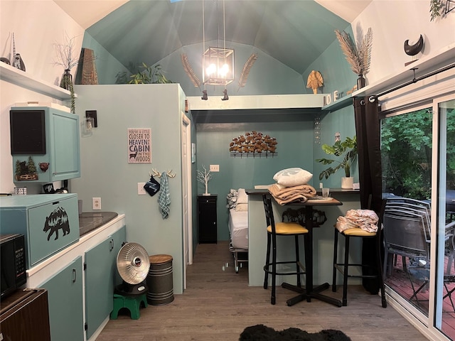 6 Rainbow Trout Ln, Pecos, NM 87552 - kitchen with a chandelier, wood finished floors, lofted ceiling, green cabinets, and black microwave