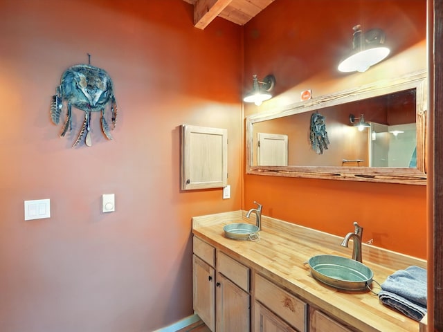 125 Apache Canyon Trl, Santa Fe, NM 87505 - bathroom featuring double vanity and beam ceiling