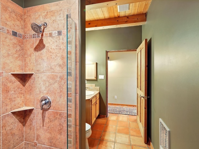 125 Apache Canyon Trl, Santa Fe, NM 87505 - bathroom featuring tiled shower, vanity, beamed ceiling, toilet, and tile patterned floors