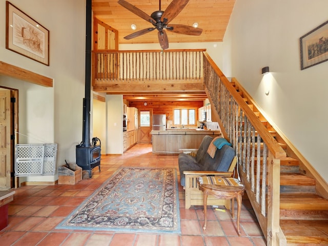 125 Apache Canyon Trl, Santa Fe, NM 87505 - living area with a towering ceiling, a ceiling fan, a wood stove, and stairway