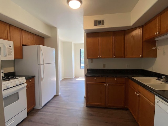 421 Maple Ave, Chama, NM 87520 - kitchen featuring white appliances, a sink, wood finished floors, and brown cabinets