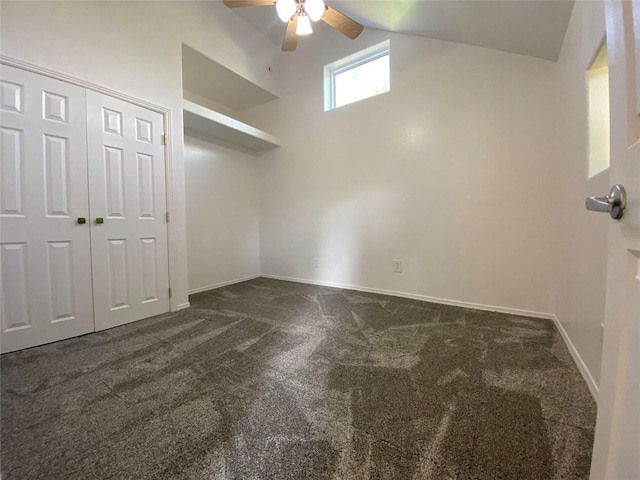 421 Maple Ave, Chama, NM 87520 - unfurnished bedroom featuring dark carpet, vaulted ceiling, baseboards, a closet, and ceiling fan