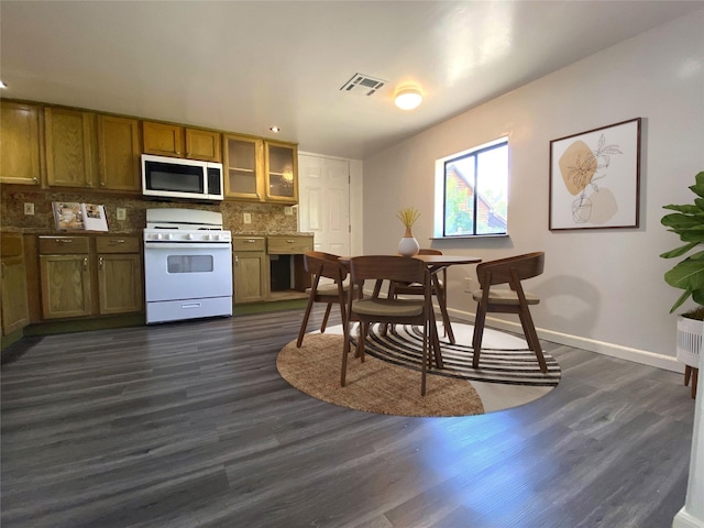 421 Maple Ave, Chama, NM 87520 - kitchen featuring white range with gas cooktop, decorative backsplash, dark wood finished floors, baseboards, and brown cabinetry