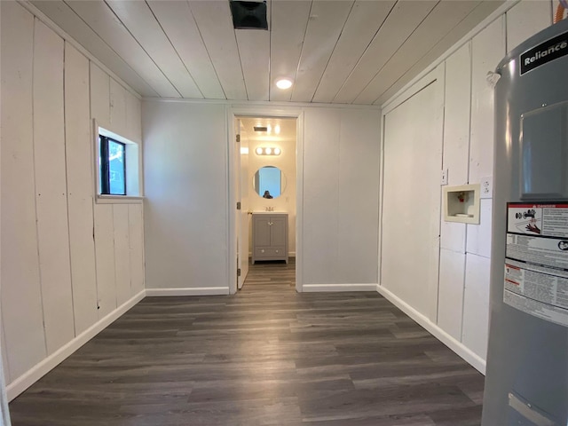 421 Maple Ave, Chama, NM 87520 - spare room with dark wood finished floors, wooden ceiling, water heater, baseboards, and a decorative wall