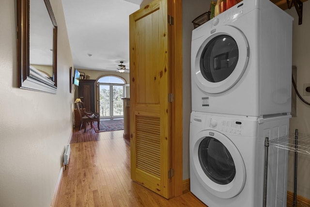 44 Sage Ln Unit 212, Angel Fire, NM 87710 - laundry room featuring stacked washer / dryer, light wood-type flooring, a ceiling fan, and baseboards