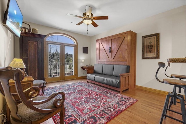 44 Sage Ln Unit 212, Angel Fire, NM 87710 - living room featuring french doors, a ceiling fan, light wood-style floors, and baseboards