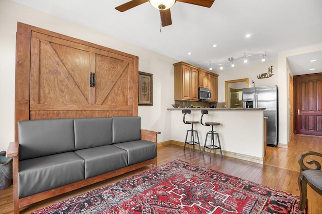 44 Sage Ln Unit 212, Angel Fire, NM 87710 - living room featuring light wood-style floors, ceiling fan, baseboards, and recessed lighting
