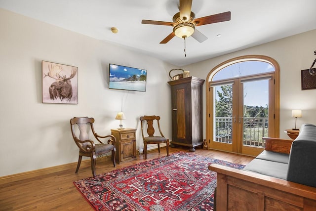 44 Sage Ln Unit 212, Angel Fire, NM 87710 - sitting room with french doors, wood finished floors, ceiling fan, and baseboards