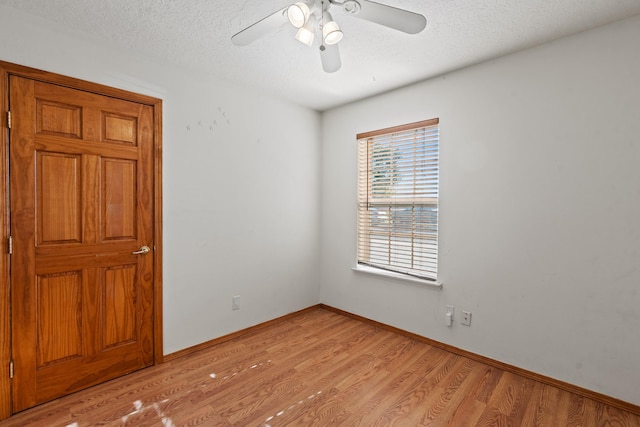 1024 Camino Vista Aurora, Santa Fe, NM 87507 - empty room with light wood finished floors, ceiling fan, a textured ceiling, and baseboards