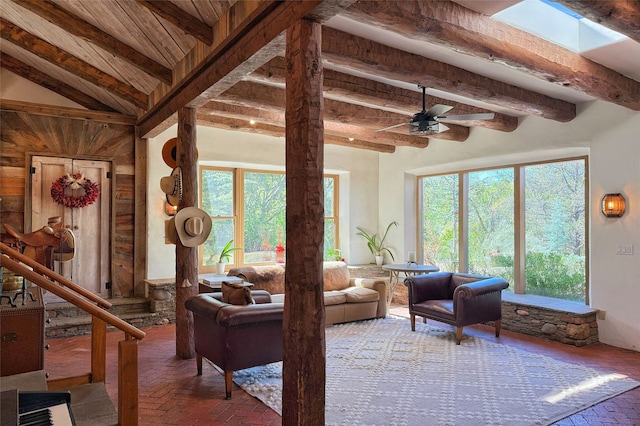 1330 Cerro Gordo Unit F, Santa Fe, NM 87501 - living room featuring brick floors, wooden ceiling with exposed beams, a ceiling fan, and wooden walls