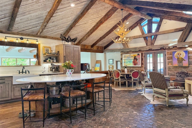 1330 Cerro Gordo Unit F, Santa Fe, NM 87501 - kitchen featuring light countertops, open floor plan, a sink, french doors, and beamed ceiling