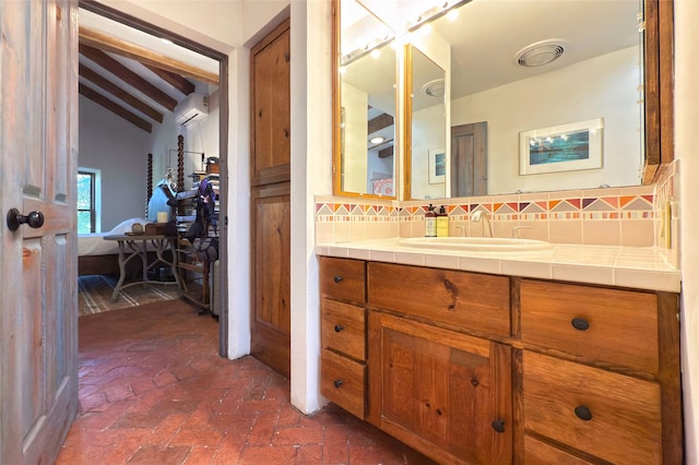 1330 Cerro Gordo Unit F, Santa Fe, NM 87501 - ensuite bathroom with a wall mounted AC, decorative backsplash, vanity, and brick floors